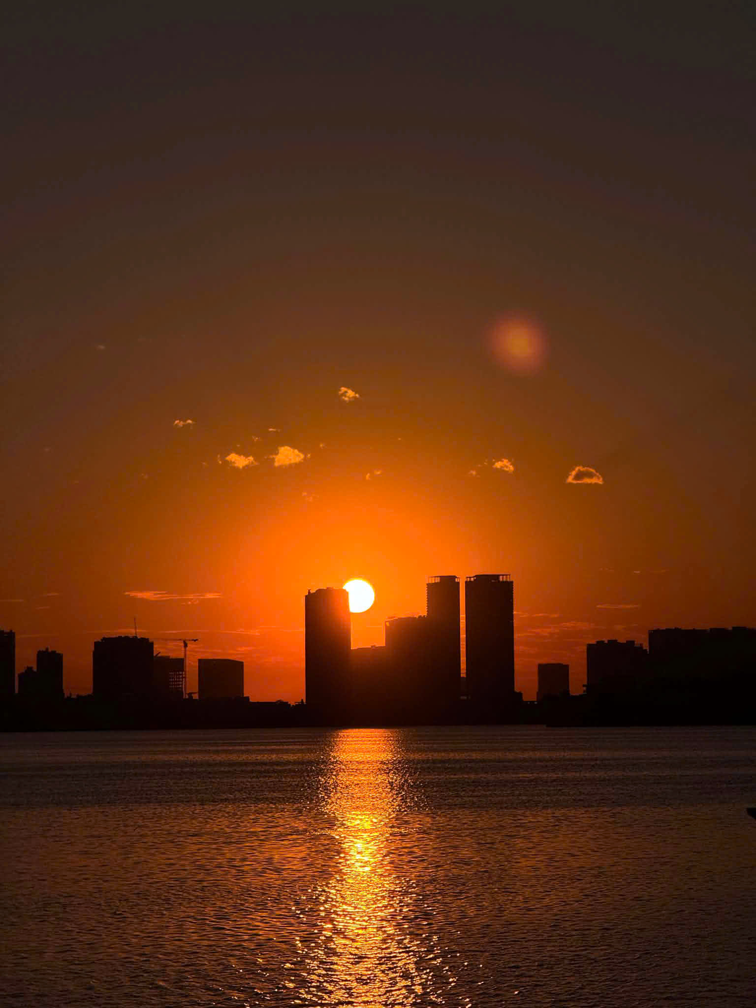 Danang's skyline silhouetted against a molten sunset over the river